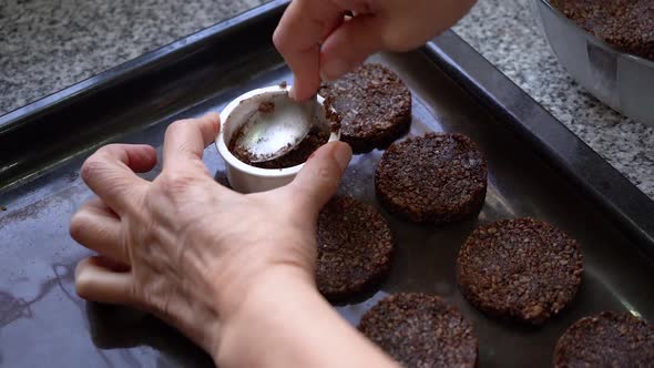 Baker With A Molder Is Making Cookies Made Of Cocoa And Seeds. Close Up