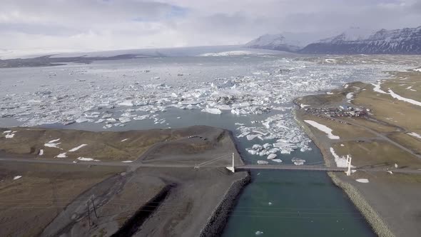 Aerial view of Jokulsarlon glacier lagoon with iceberg floating and mountains