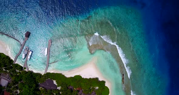 Tropical above abstract shot of a paradise sunny white sand beach and turquoise sea background in 4K