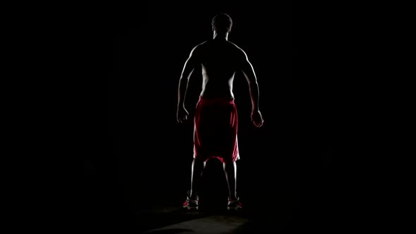 Man Stretching Isolated on Black