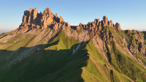 Dolomites mountains peaks with a hiking path on a summer sunrise