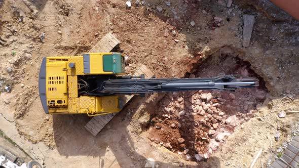 Top View Of Excavator Working At Construction Site. - aerial ascend