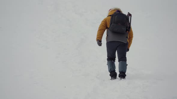 Traveler on Snowy Mountain in Winter