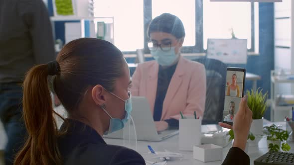 Back View of Freelancer Man with Face Mask Talking on Videocall Meeting