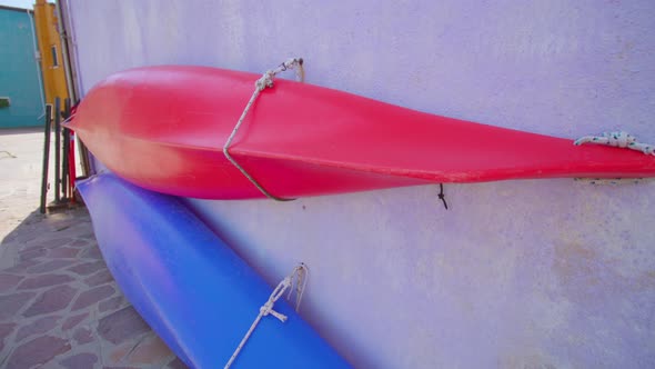 Canoe Boats Attached Tightly to Wall of House in Burano