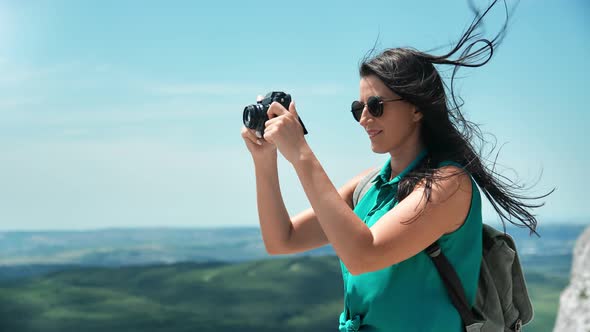 Happy Travel Woman with Waving Hair Taking Photo of Landscape Use Camera