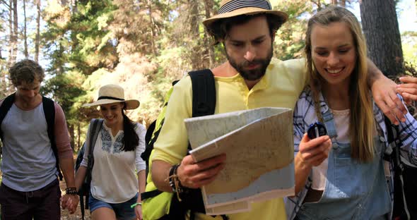 Hiker couples walking and looking maps