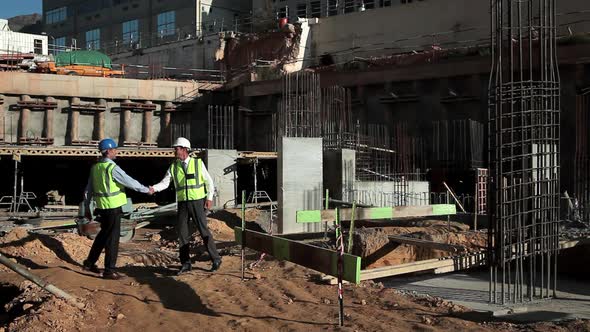 Mature men meeting on construction site