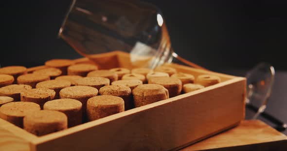 Wine Corks and Glass on an Old Vintage Wooden Board