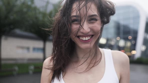 Close up view of Happy and Smiling Woman. Running and Jumping While the Weather is Rainy.