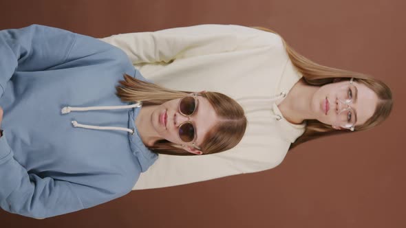 Vertical Portrait of Twin Sisters in Glasses