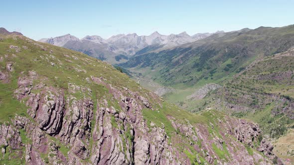 Large winding river between the huge barely vegetated mountains in the Valle de Hecho Y near Huesca