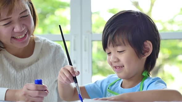 Cute Asian Child And Mother Painting Together