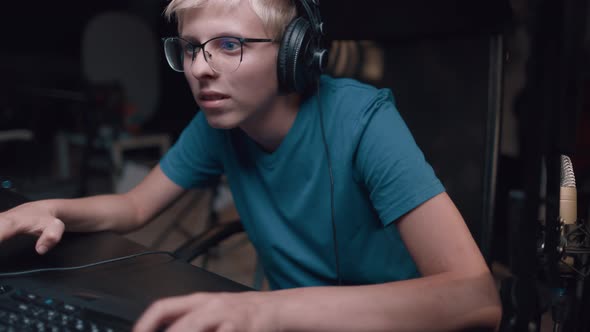 Caucasian Young Teen Guy Plays Games On Computer And Streams The Games Live