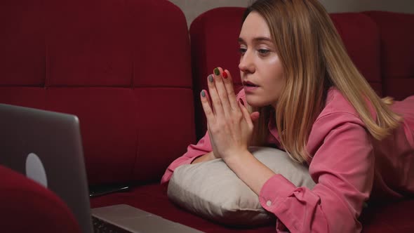 Close Up Tired Sad Woman Face Looking at Laptop at the Home Lying on Sofa