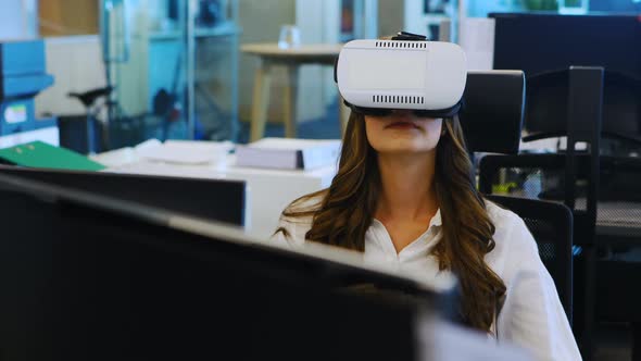 Female executive using virtual reality headset