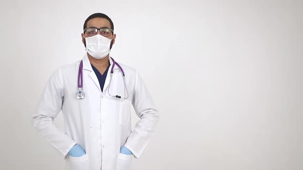 Arab young doctor in medical mask smiling at camera. The end of the coronavirus pandemic