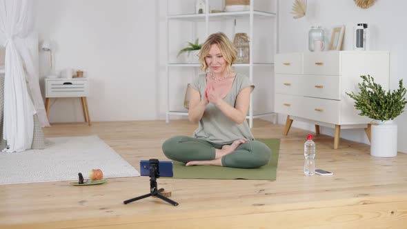 Professional Yoga Instructor Greeting Followers While Giving Online Class