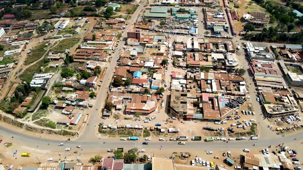 Aerial flyover poor Kibera Slum and modern skyline of Nairobi in background during sunny day. Two cl