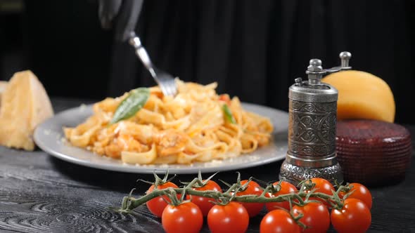 Eating Seafood Pasta with Shrimps Grated with Hard Cheese By Rolling Spaghetti with Fork