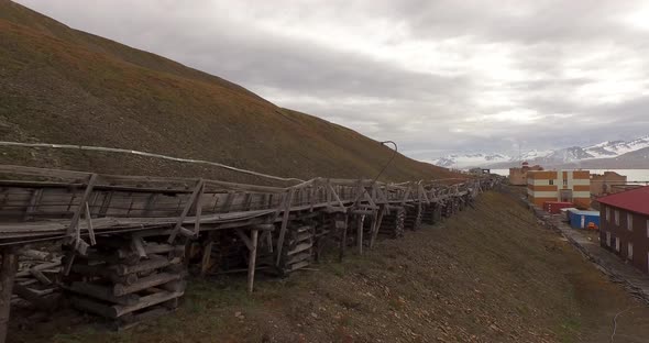 Drone Flight Over the Pipe Stretching By the Ground Along the Settlement of Barentsburg. Spitsbergen