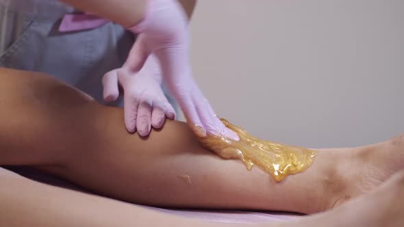 Closeup of Placing Wax on Client's Leg for Hair Removal
