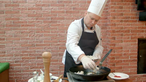 Chef Putting Fresh Seafood To a Pan