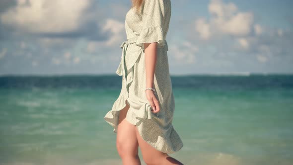 Girl Walking On Tropical Beach.Flowing Dress Blowing In Wind. Relax On Caribbean Resort. Travel Mood