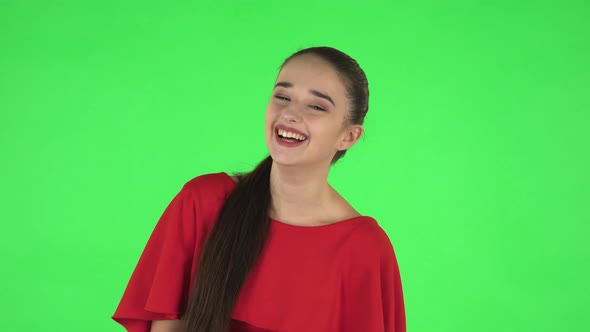 Portrait of Pretty Young Woman Is Laughing. Green Screen
