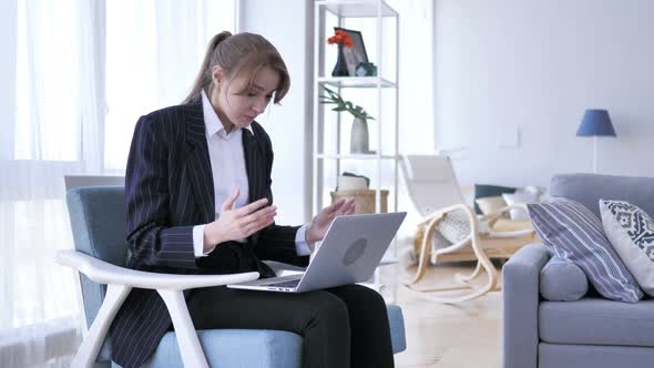 Upset Woman Working on Laptop in Office