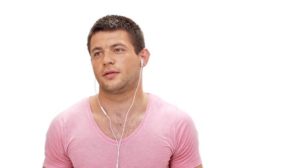 Man Listening Music in Headphones Smiling Over White Background Slow Motion