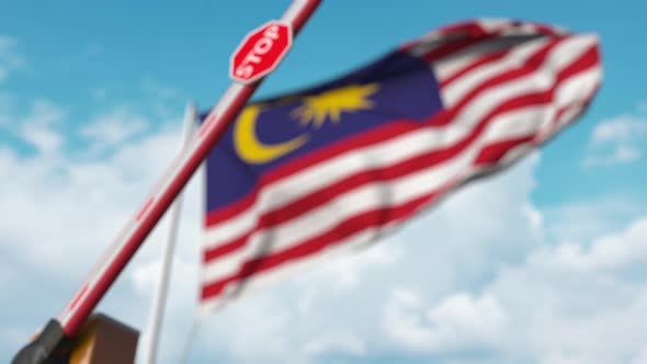 Barrier Gate Being Closed at Flag of Malaysia alt