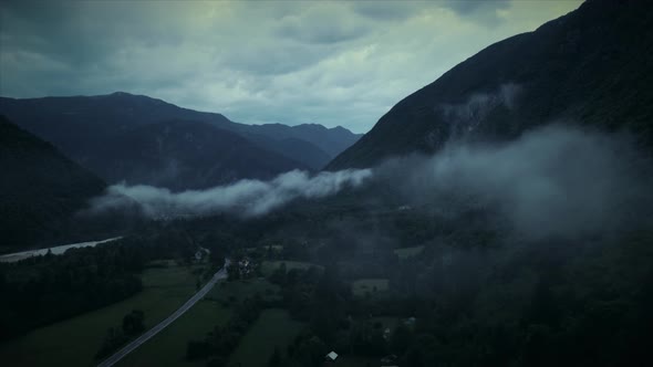 Aerial view of Soca river valley with misty clouds in full nature, Slovenia.