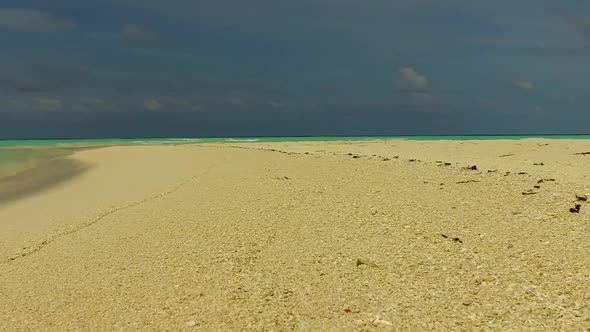 Summer texture of seashore beach by blue ocean with sand background near sandbar