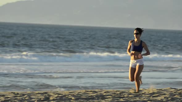 Woman running on the beach.