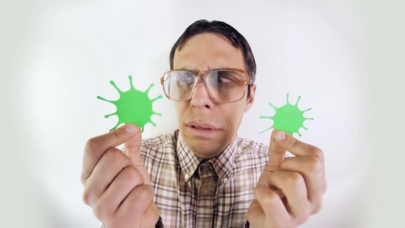 Funny Man Looks at Coronavirus in Hands alt