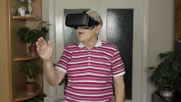 Senior Grandfather Man in Virtual Headset Glasses Watching 3d Video in 360 Vr Helmet at Home