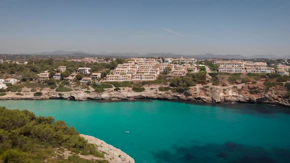 AERIAL: Drone flying above turquoise sea on touristic beach, mallorca