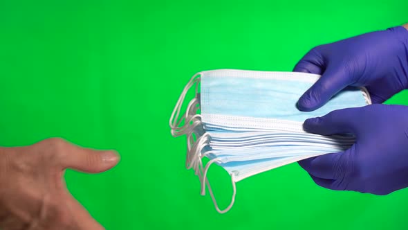 Hands Wearing Protective Gloves Giving Medical Protective Masks