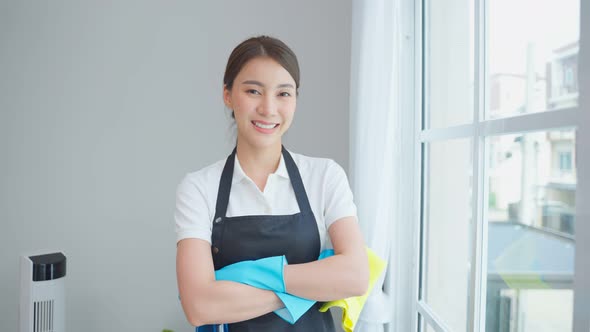 Portrait of Asian young cleaning service woman worker working in house.