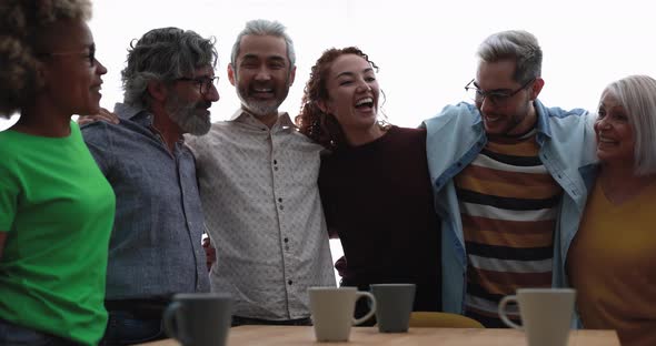 Happy multiracial friends having fun together at home kitchen