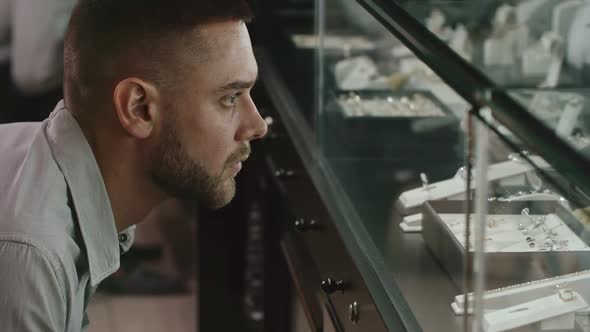 Man Looking for Perfect Gift on Luxury Shop Display