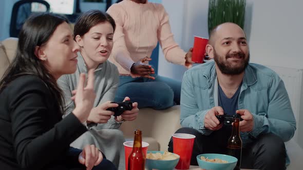 Close Up of Man and Woman Using Controllers to Play