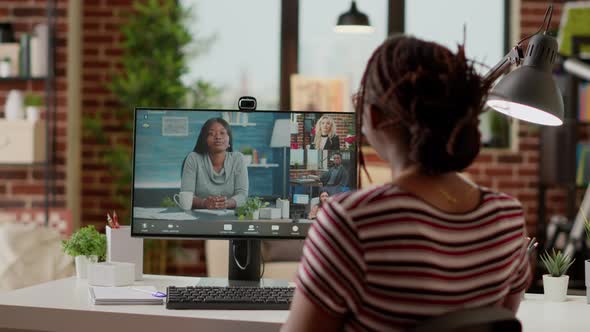 Office Worker Using Online Videocall Conference to Talk to Colleagues