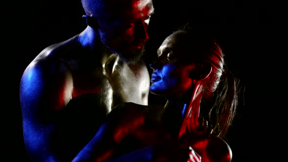 Body Art Sensual Lovers are Stroking Bodies Covered Shiny Dye in Darkness Art Light