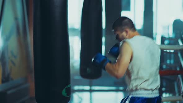 Active Man Practicing His Punches Gym