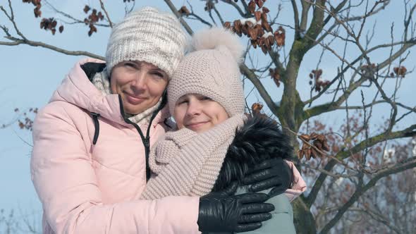 Lovely Mother with Child in Winter Park