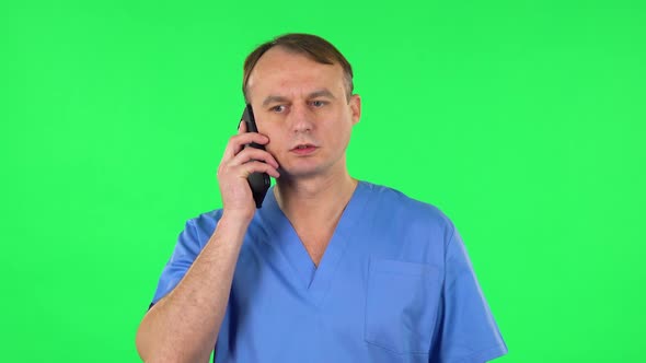 Medical Man Angrily Speaks on the Phone, Proves Something. Green Screen