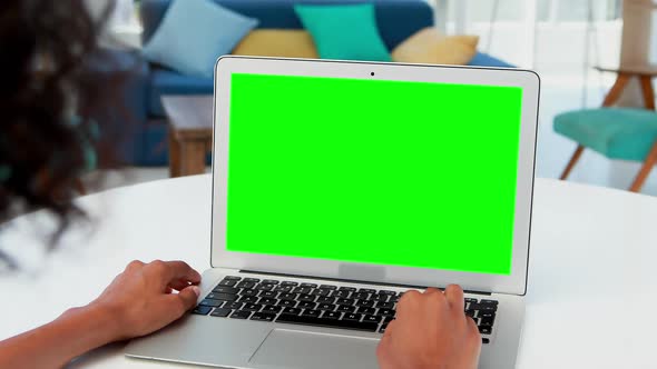 Female executive working on laptop at desk 4k