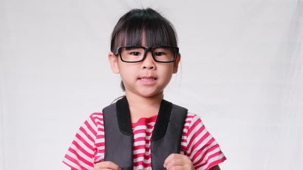 Cute schoolgirl wearing glasses with backpack , she nice-looking, charming and enjoying a good